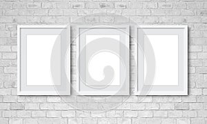 Three Vertical Frames On White Brick Wall. 3 Picture Frame Empty Blank with white borders Hanging in Grey Bricks Background.