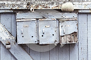 Three very old and grungy mailboxes