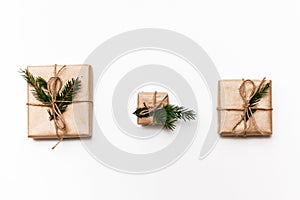 Three Vintage gift boxes with spruce branches on white isolated background, top view