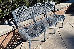 Three vintage green metal garden chairs bench