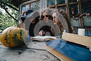 Three vintage witches perform magic ritual
