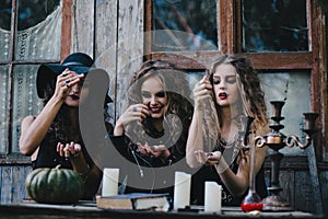 Three vintage witches perform magic ritual