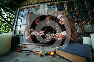 Three vintage witches perform magic ritual