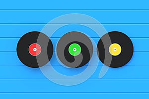 Three vinyl records on blue background