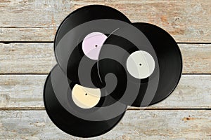 Three vinyl records with different labels.