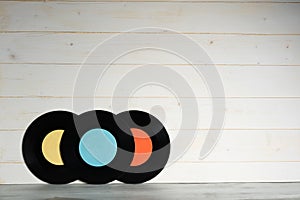 Three Vinyl records on wooden background