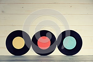 Three Vinyl records yellow red and blue