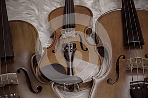 Three violins put on background,show detail and different size