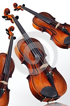 Three violins on white background