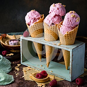 Three waffle cones with pink ice cream