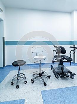 Three waiting or sitting chairs kept in a hospital reception. Chairs for meeting in corridor near wall.