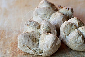 Three walnuts breads on a wooden cutting board