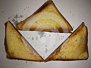 Three warm half-burnt toast on a white background.