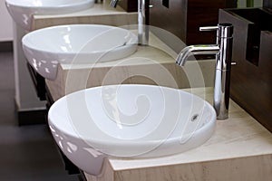 Three of wash basins and faucets