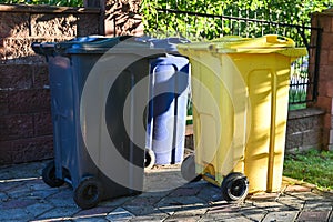 Three waste bins for mixed waste are in the yard