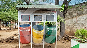 Three waste recycling bins outdoors