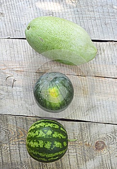 three watermelons on the wooden boards