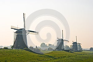 Three watermills after sunrise
