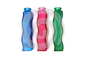 Three wavy glass flower vases of different colors