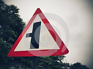 Three way junction warning sign board, intersection traffic sign on the roadside