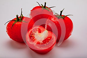 Three wet tomatoes plus one cut