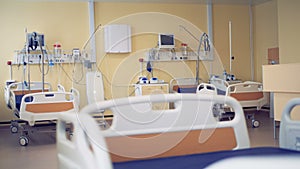 Three wheeled beds are being shown in a modern hospital room