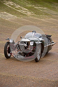 Three wheeled Morgan Super Sport car on the curved banking of Brooklands racetrack. Surrey, England.