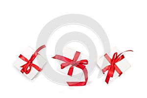 Three white boxes with red bows on a white background