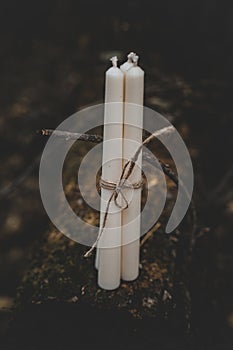 Three white candles tied with twine