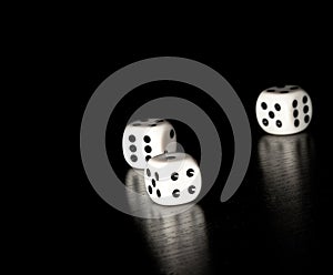 Three white dice on old wood black table with space for text