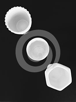 Three white glass vases with black background