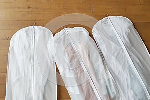 Three white Hanging Garment Bag on the floor. The morning before the wedding. Pack your things on a trip or sort and hang up your