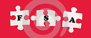 Three white jigsaw puzzles with the text FSA Flexible Spending Account on a bright red background