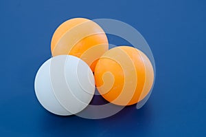 Three White and orange ping pong ball