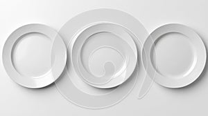 Three empty white ceramic dinner plates arranged in a row on a clean white background