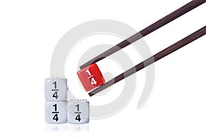 Three white quarter fraction dices on white table and red quarter fraction dice held by wooden chopsticks photo