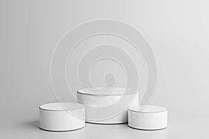 Three white round podiums for product presentation on gray background. Blank product three podium. Minimal scene mockup with 3