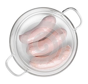 Three white sausages in a glass saucepan isolated on white above
