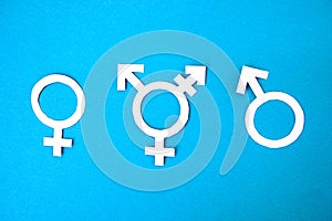 Three white symbols for gender on blue background. concept transgender