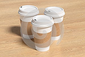 Three white take away coffee paper cups mock up with white lids on wooden background