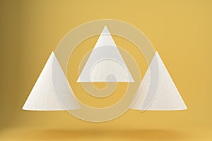 Three white triangles with paper texture on a yellow background