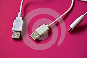 Three white USB connectors on a red background