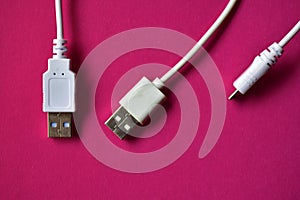 Three white USB connectors on a red background