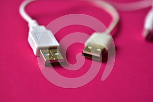 Three white USB connectors on a red background