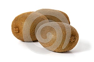 Three whole kiwi fruit on white background. Front view. Full depth of field