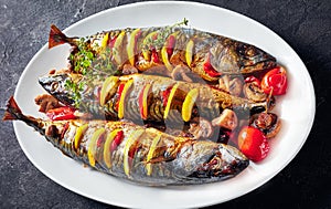 Three whole roasted mackerel on an oval dish