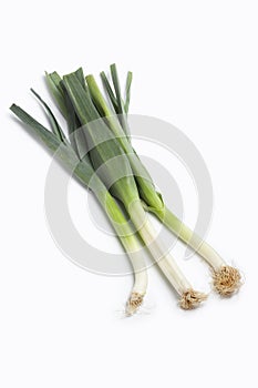 Three whole stems of green leeks photo