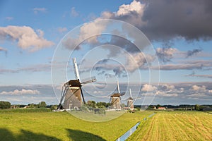 Three windmills in the countryside in the Netherlands