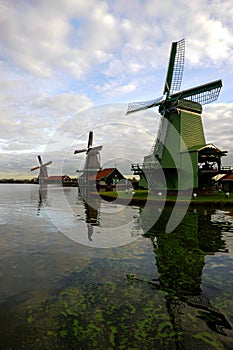 Three windmills at dawn in the Netherlands.