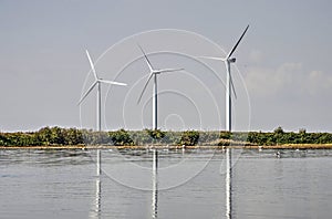 Three windmills reflecting